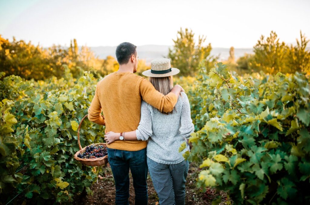 A husband supporting his wife through menopause by picking ingredients in a field together.