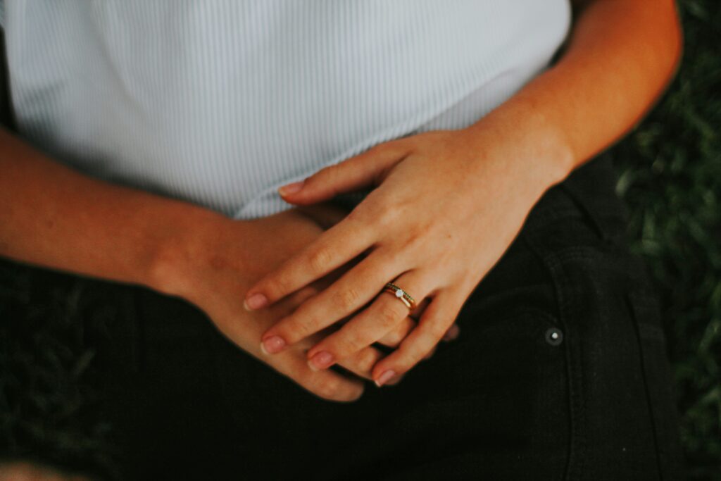 Woman struggling with menopause bloating - her hands are over her stomach.