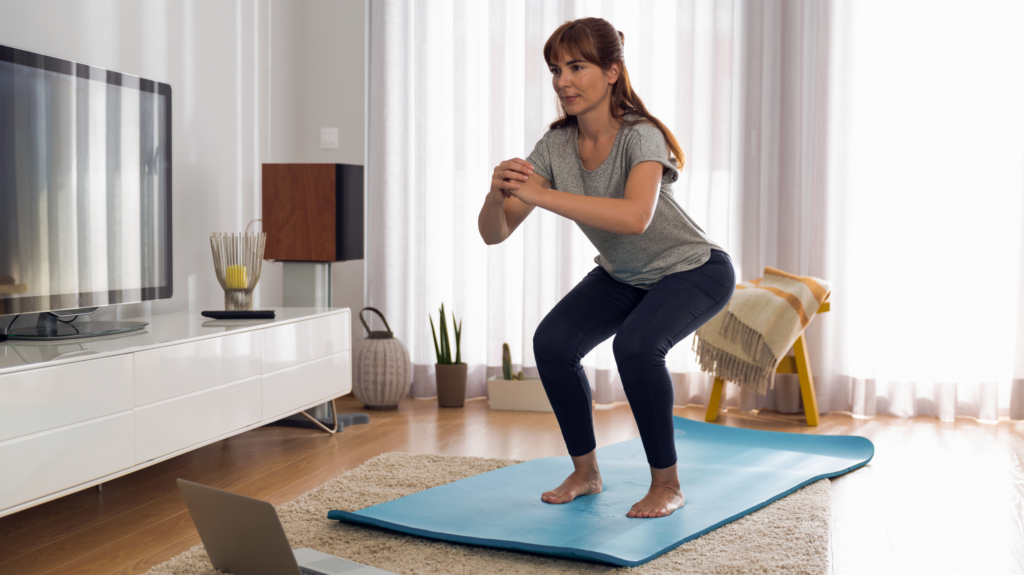A perimenopausal woman doing exercise on a yoga mat to combat menopause and hot flashes