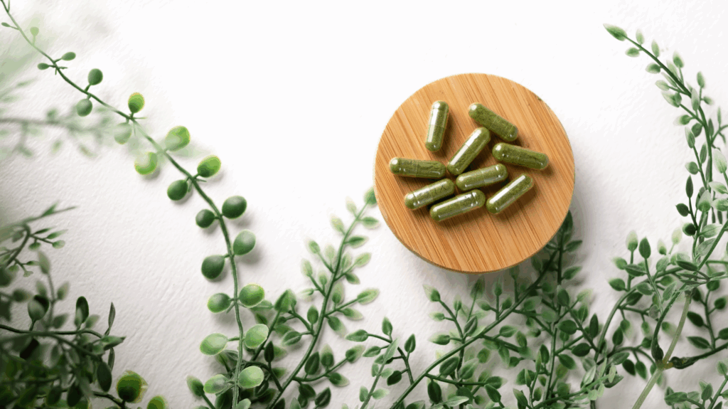 Supplements for joint pain on a round wooden plate with vines surrounding them.